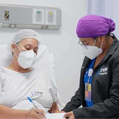 Nurse a patient filling a pre-op form